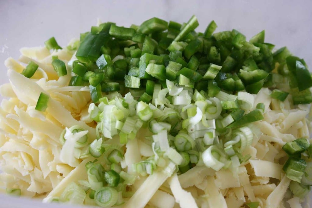 Thinly slice white parts of green onions and add to mixing bowl.